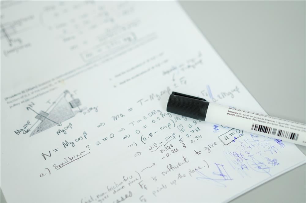  notebook with scribbles and pen resting on top