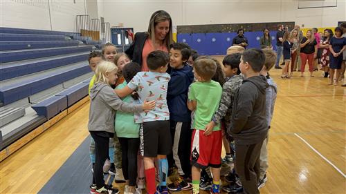 Shaina Brenner gets a hug from the students in her class.