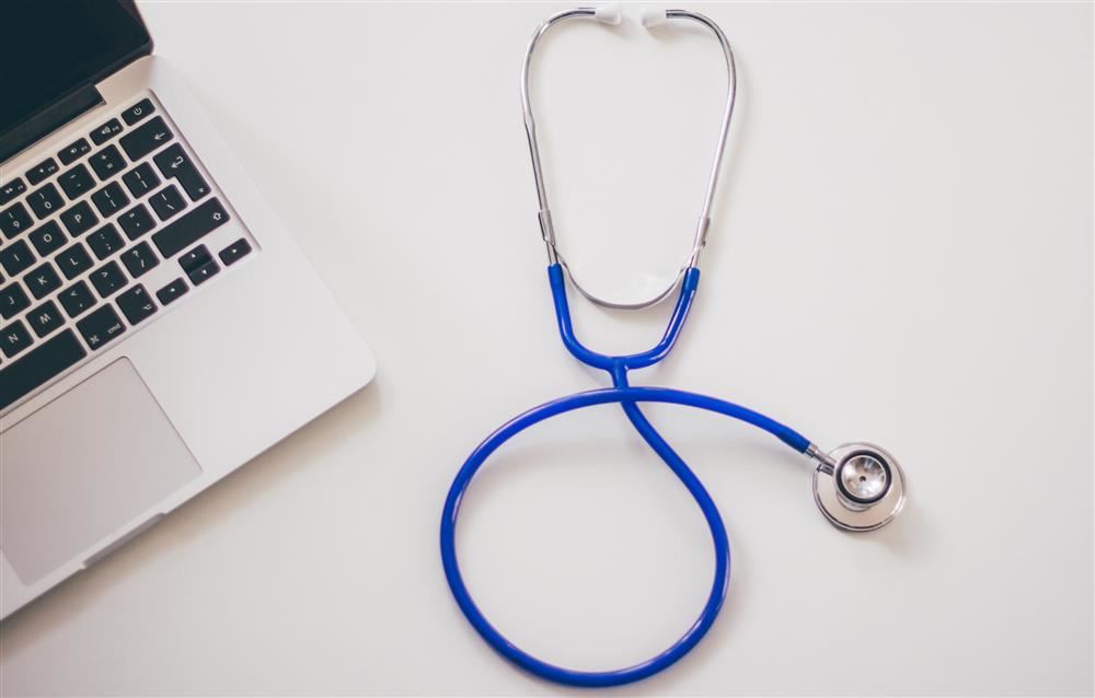  Stethoscope on table near laptop