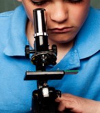 student looking into a microscope